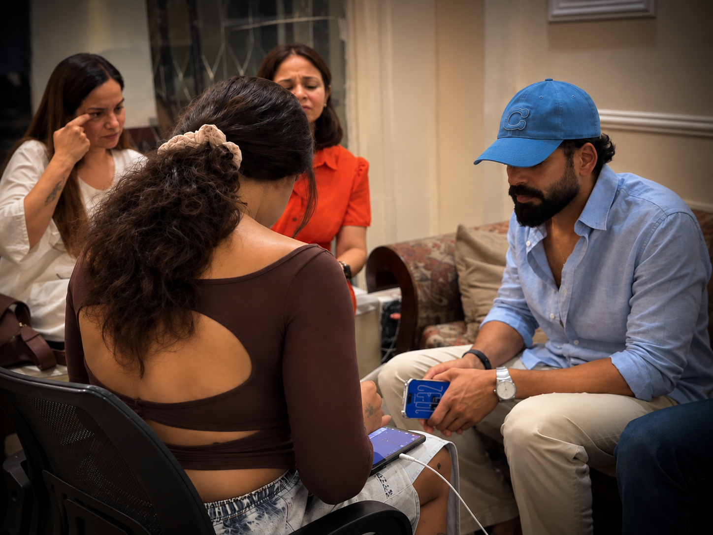 Tattoo artist and client discussing tattoo ideas during a consultation in a studio.