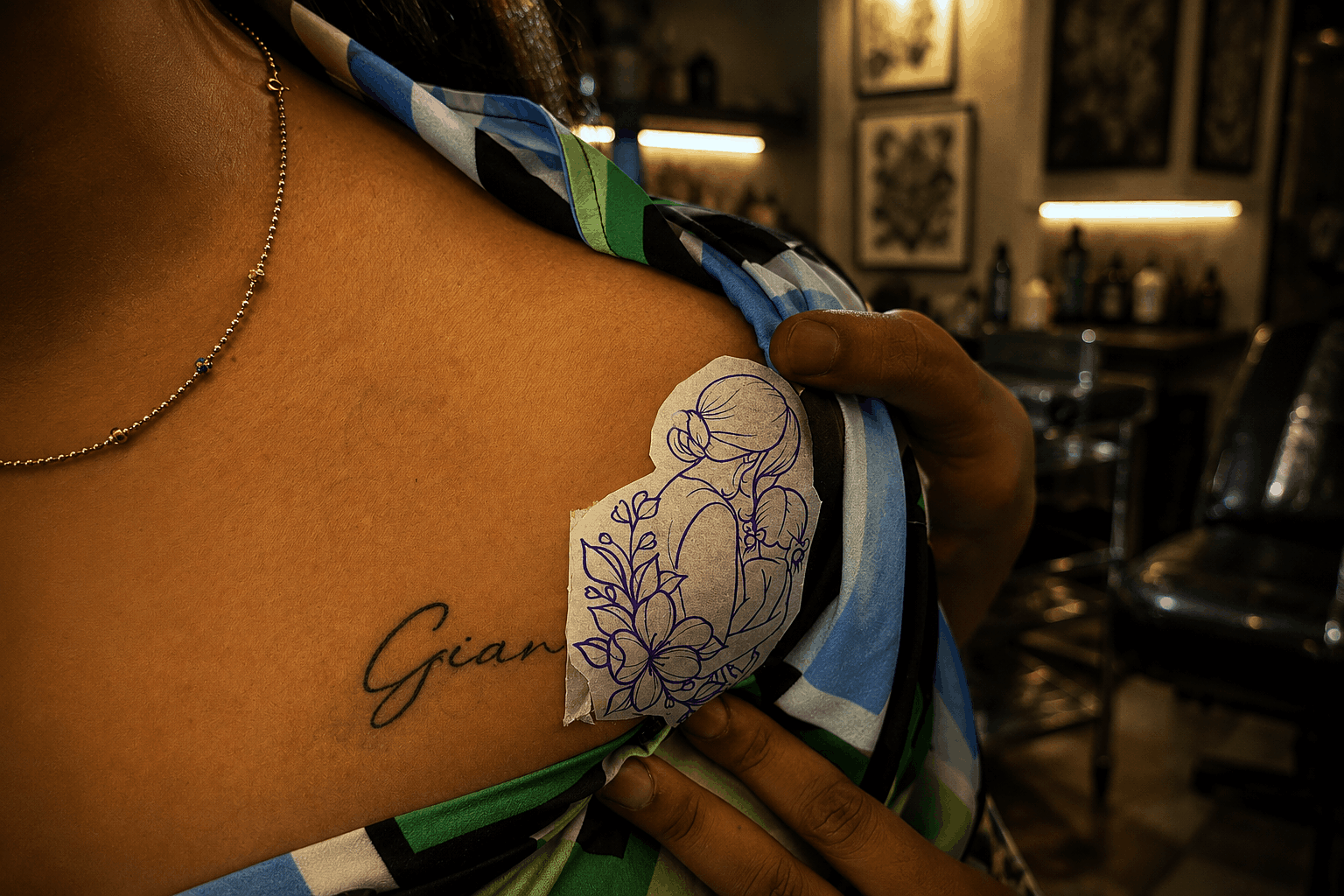 An authentic tattoo artist at Inkspace Tattoo Studio in Hauz Khas, New Delhi, works on transforming an ex's name tattoo while the client looks on, showcasing th