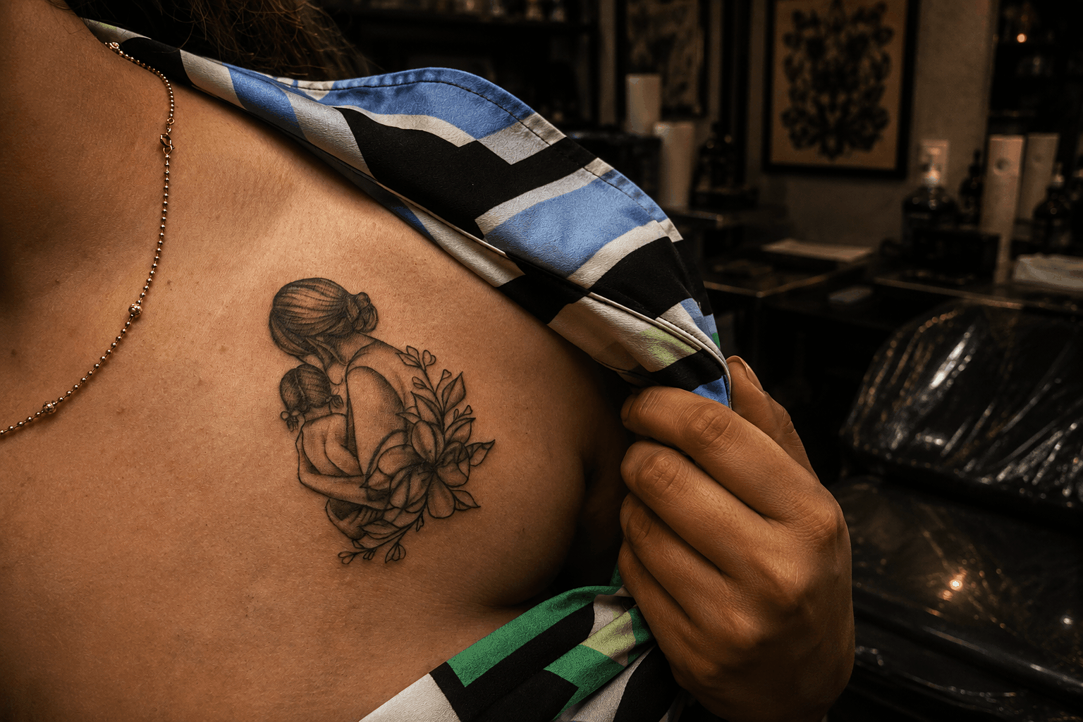 An editorial photograph showcasing a tattoo artist at Inkspace Tattoo Studio in Hauz Khas, New Delhi, discussing cover-up designs with a client.