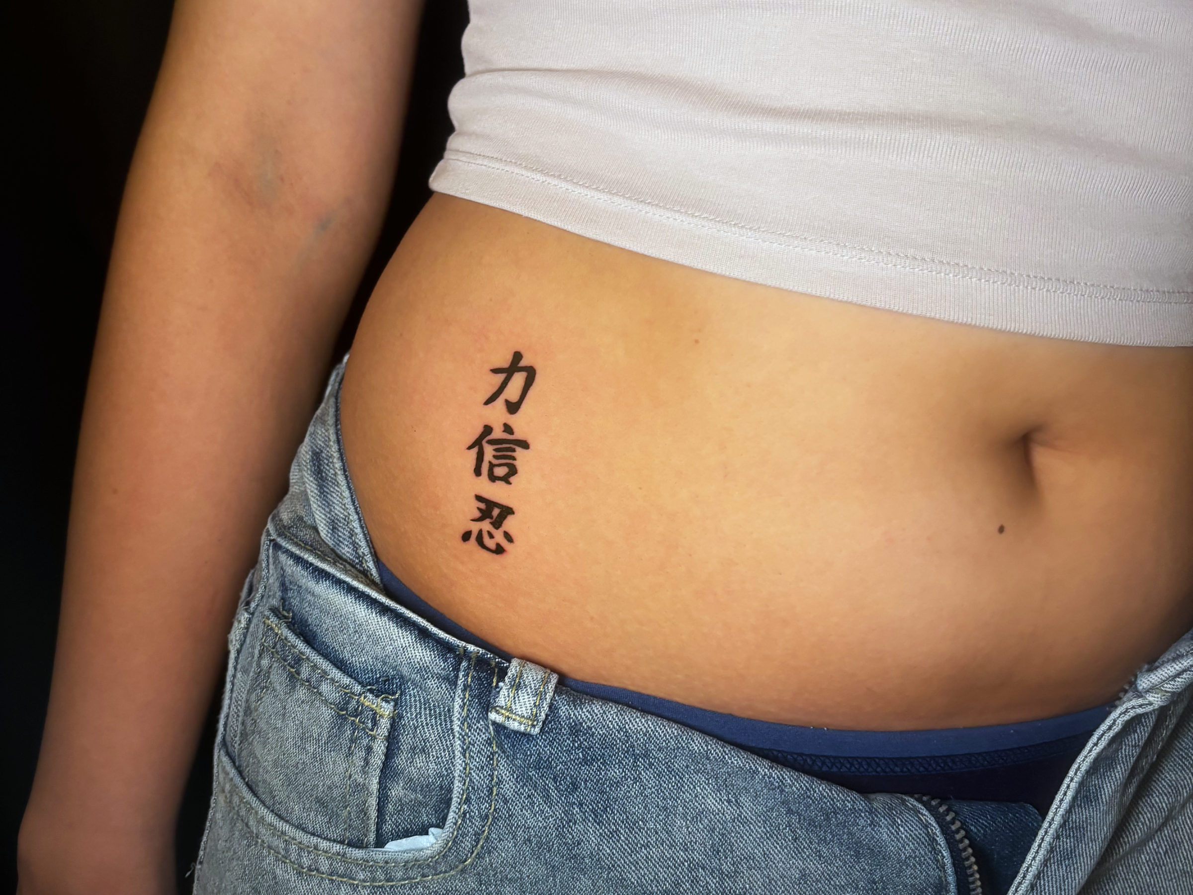 An editorial photograph of a tattoo artist at Inkspace Tattoo Studio in Hauz Khas, New Delhi, showcasing tattoo placement and its impact on perception.