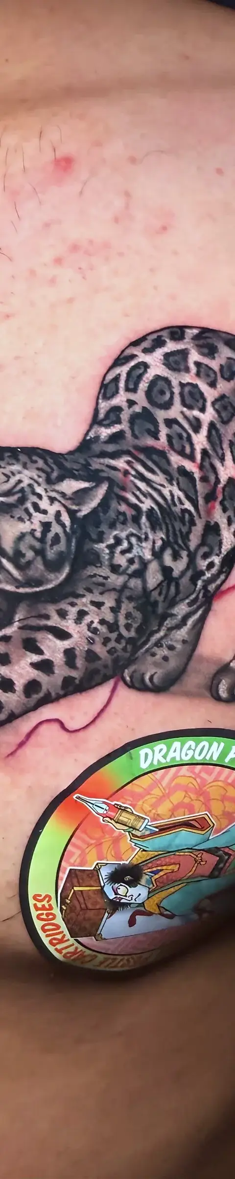 Realistic cheetah cover up tattoo on arm