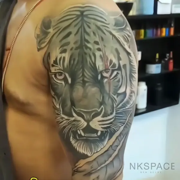 Roaring Tiger Tattoo: Cover Up Tattoo — bicep placement — by Chetan Salhotra — Inkspace Tattoo Studio, Hauz Khas Village, New Delhi Dynamic cover up roaring tiger tattoo in black and grey, expertly executed by Chetan Salhotra.