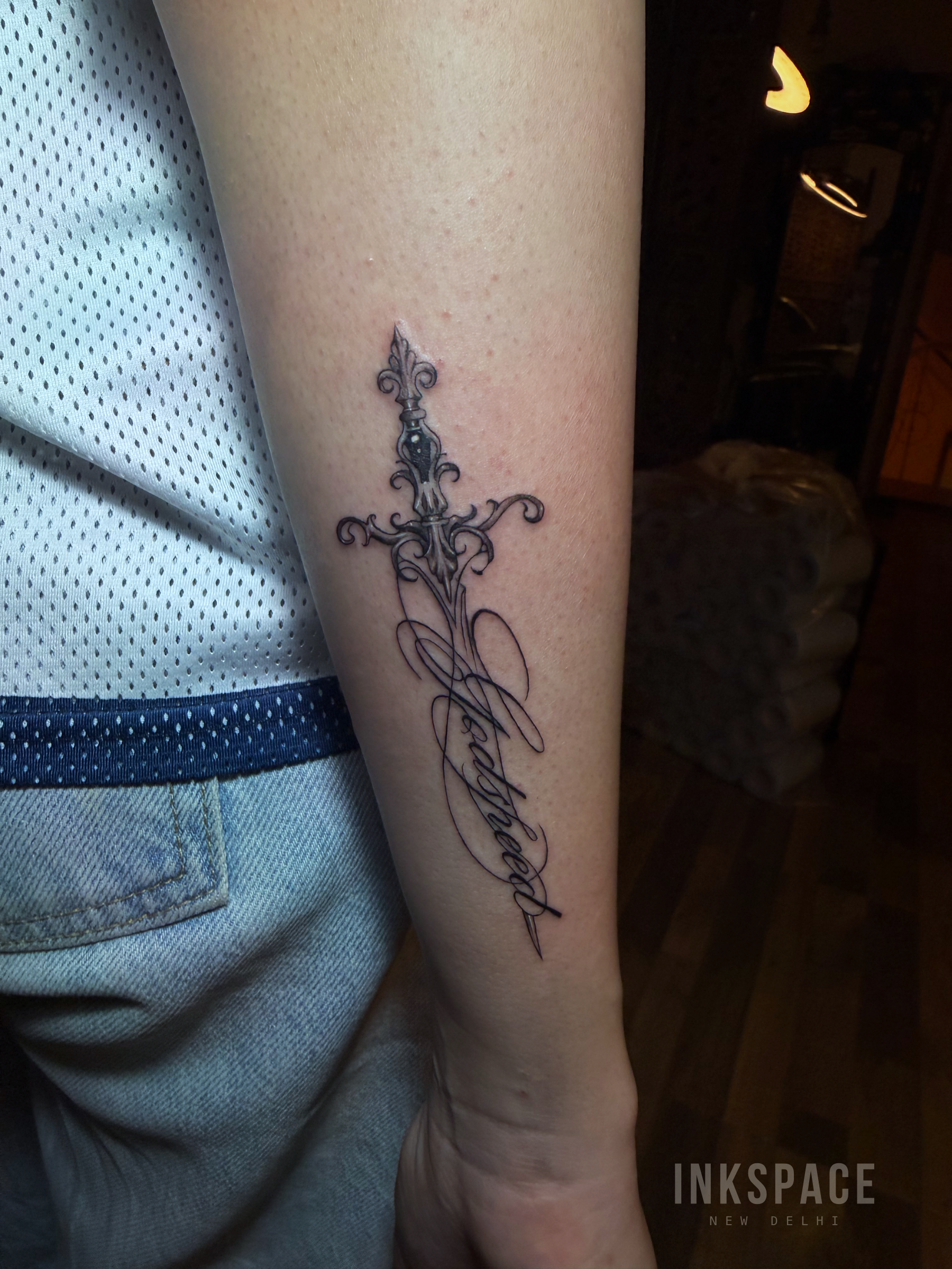fine line ornamental sword tattoo design