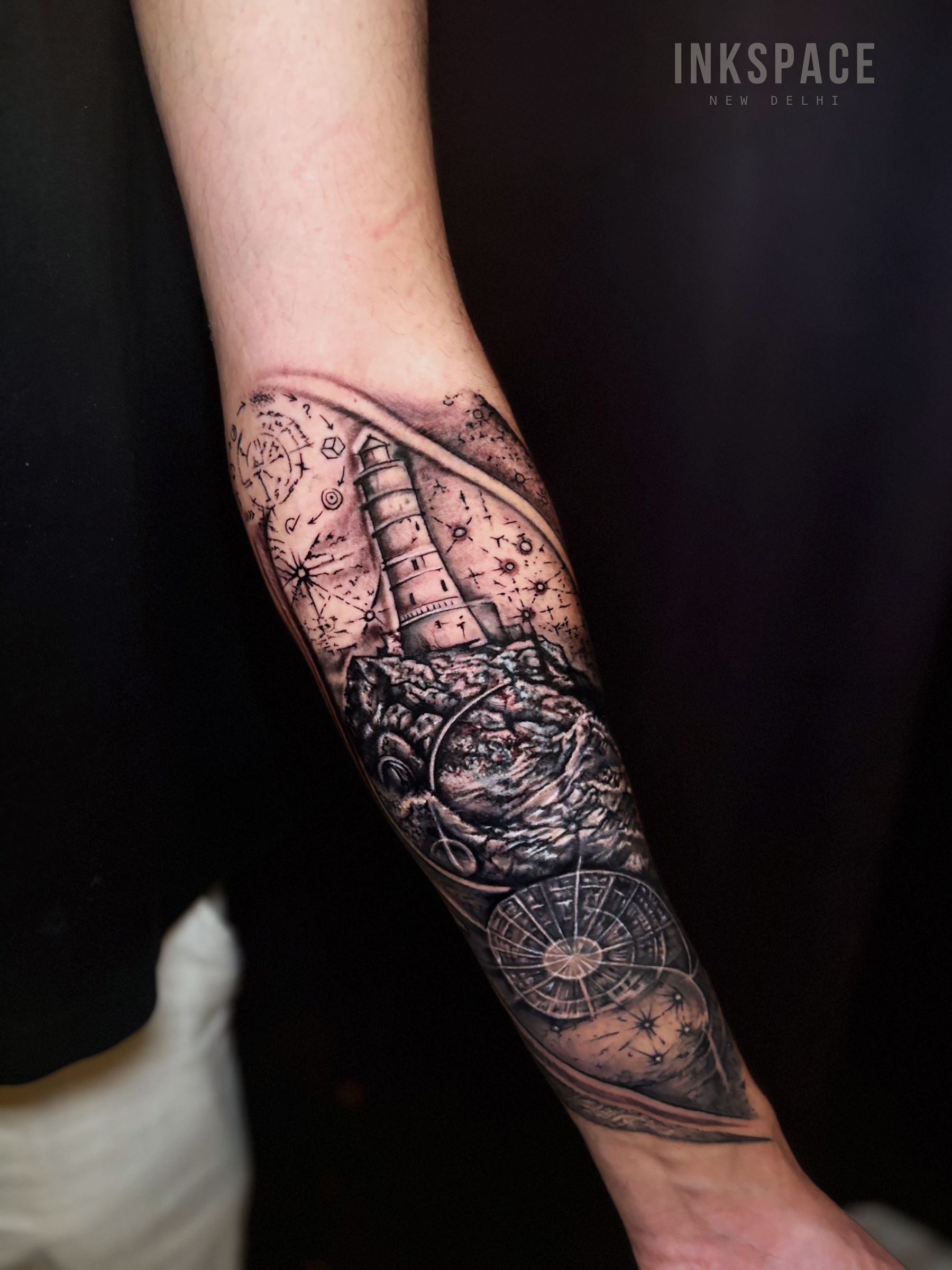 realism lighthouse and compass tattoo sleeve