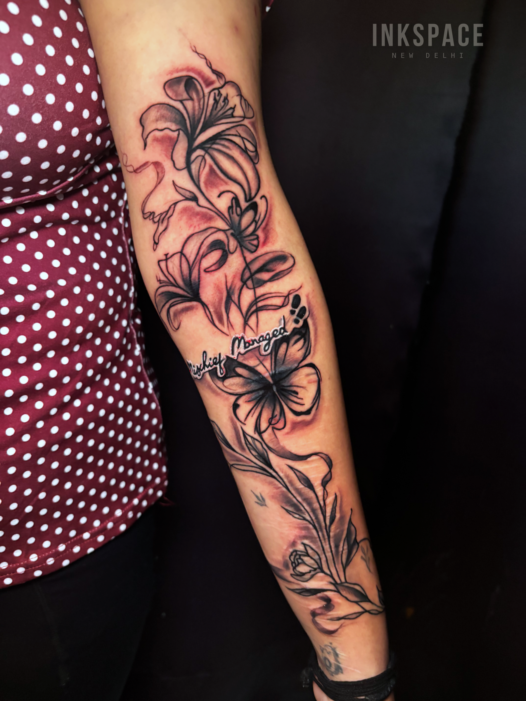 fine line floral sleeve tattoo showcasing intricate flowers