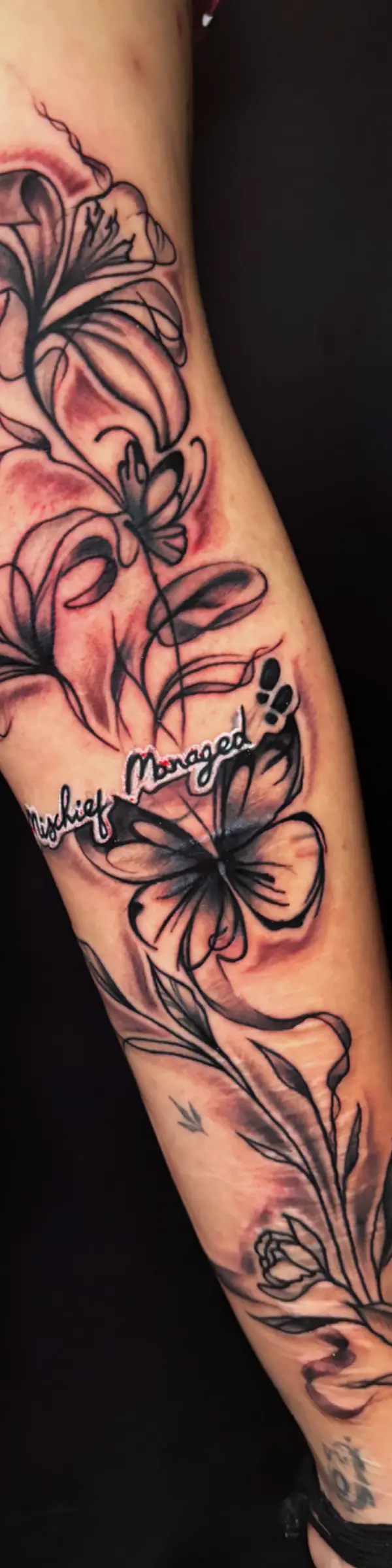 fine line floral sleeve tattoo showcasing intricate flowers