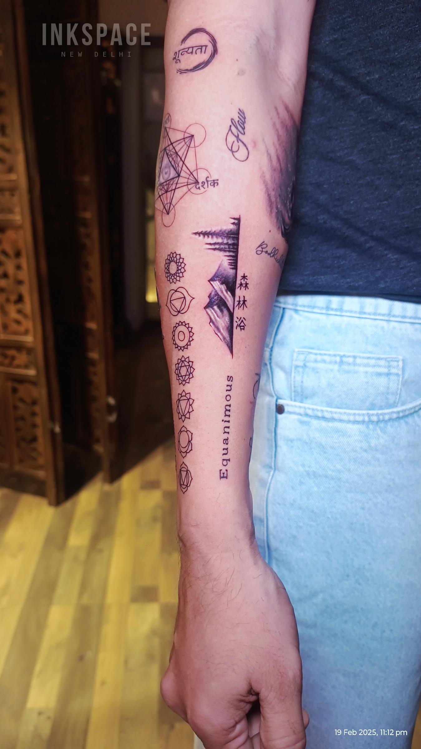 fine line sleeve tattoo showcasing personal symbols
